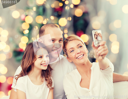Image of happy family with camera at home