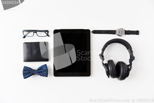 Image of tablet pc, headphones with hipster personal stuff