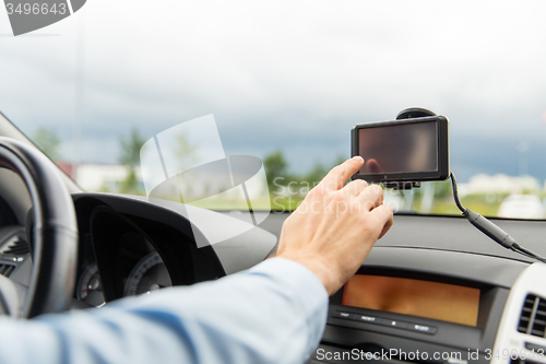 Image of close up of man with gps navigator driving car