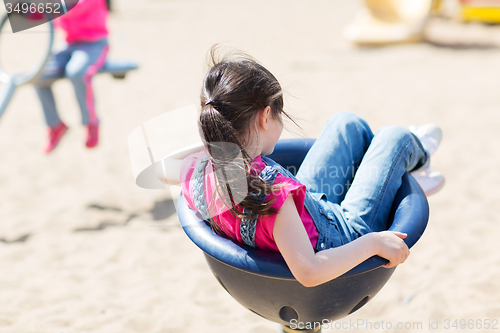 Image of close up of girl playing on children playground