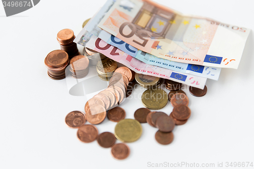 Image of close up of euro paper money and coins on table