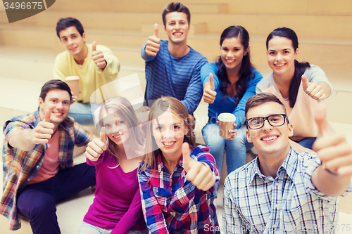 Image of group of smiling students with paper coffee cups