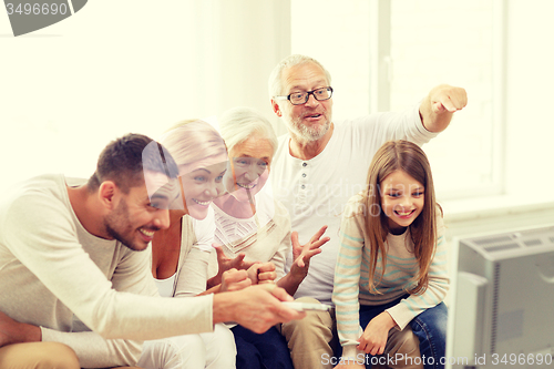 Image of happy family watching tv at home