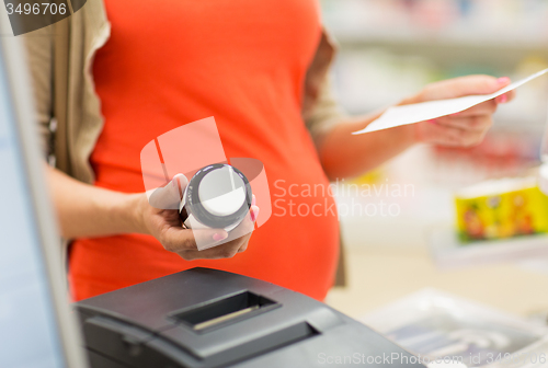 Image of pregnant woman buying medication at pharmacy