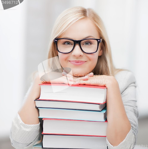 Image of student with stack of books