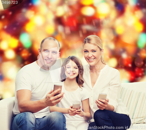 Image of happy family with smartphones