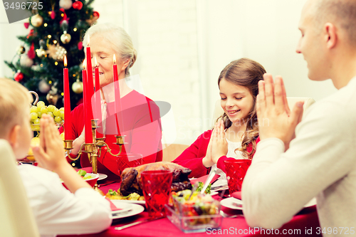 Image of smiling family having holiday dinner at home