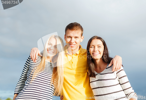 Image of group of happy friends over sky background