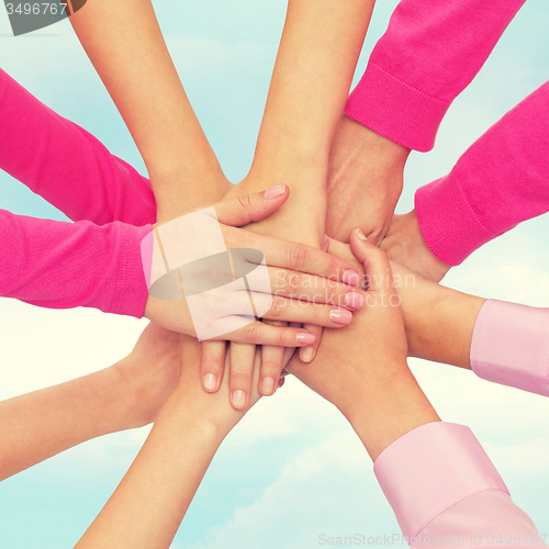 Image of close up of women with hands on top