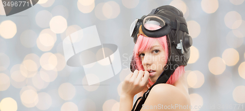 Image of girl in aviator helmet over holidays lights