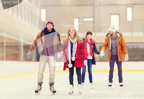 Image of happy friends on skating rink