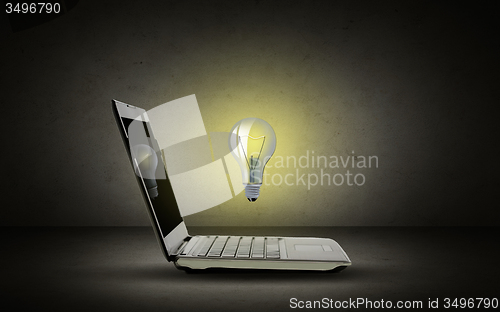 Image of open laptop computer with lighting bulb