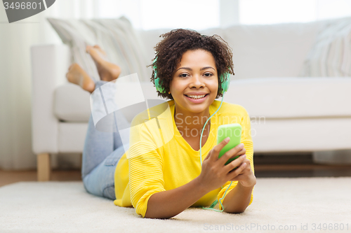 Image of happy african woman with smartphone and headphones