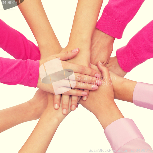 Image of close up of women with hands on top