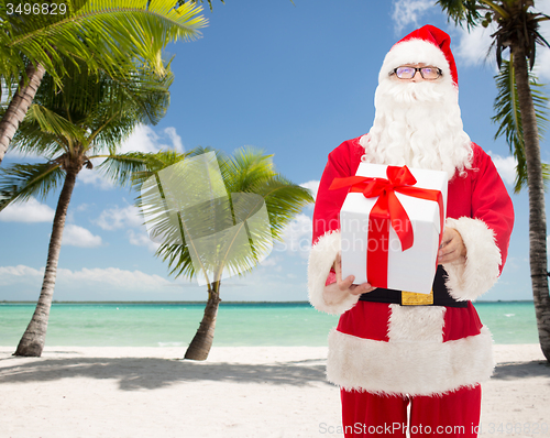 Image of man in costume of santa claus with gift box