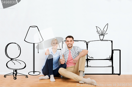 Image of happy couple showing thumbs up at new home