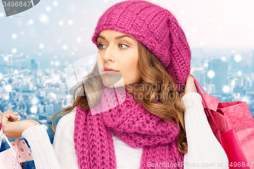 Image of young woman in winter clothes with shopping bags