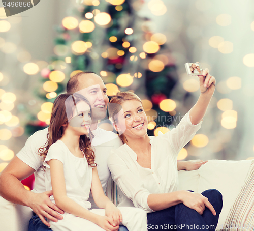 Image of happy family with camera at home