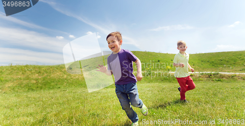 Image of happy little boys running outdoors