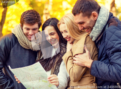 Image of group of friends with map outdoors