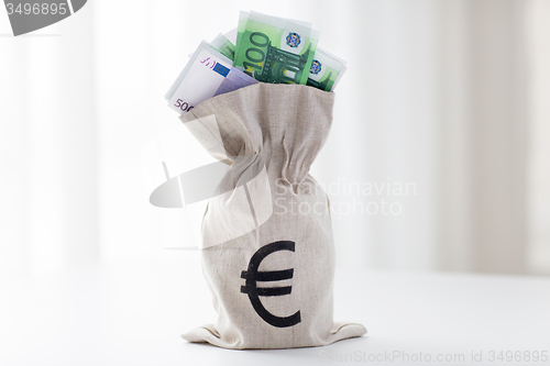 Image of close up of euro paper money in bag on table