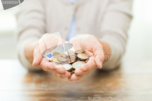 Image of close up of senior woman hands holding money