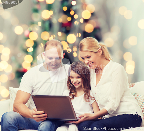 Image of smiling family with laptop
