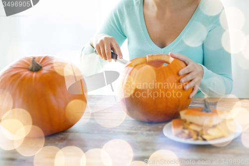 Image of close up of woman with pumpkins at home