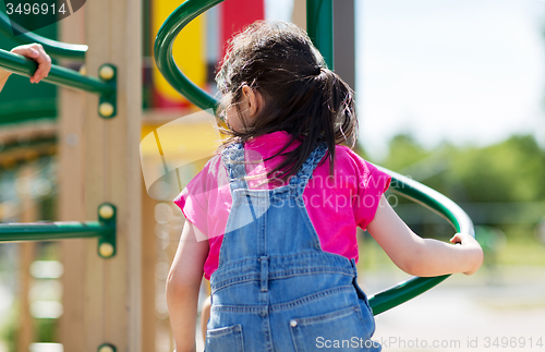 Image of close up of girl climbing on children playground