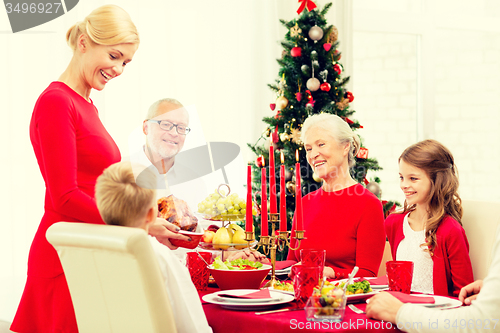 Image of smiling family having holiday dinner at home