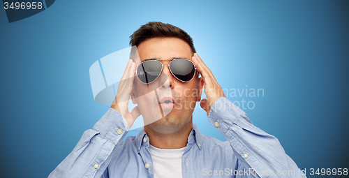 Image of face of scared man in shirt and sunglasses