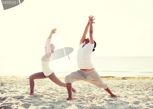 Image of couple making yoga exercises outdoors