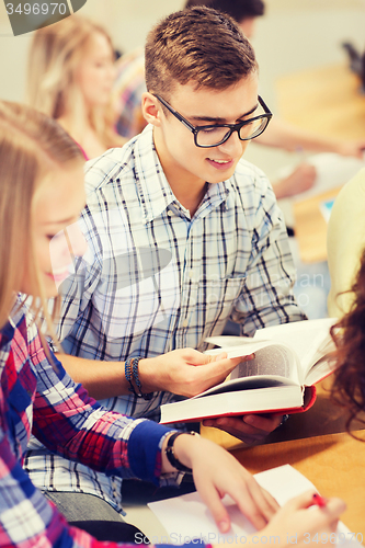 Image of group of smiling students with books