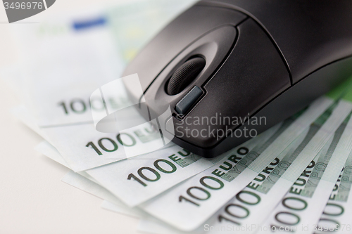 Image of close up of computer mouse and euro cash money