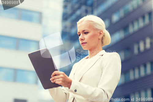 Image of businesswoman working with tablet pc outdoors