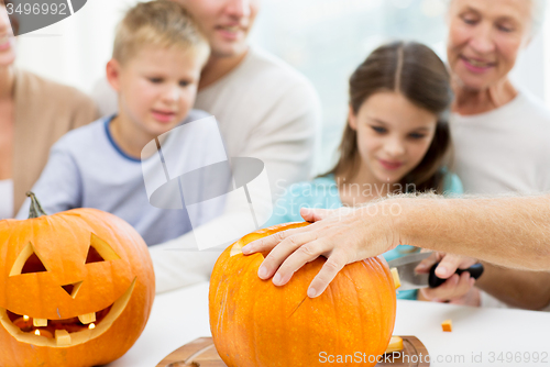 Image of family making lantern of pumpkins for helloween