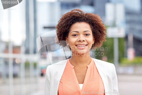 Image of happy young african american businesswoman in city