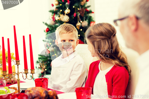 Image of smiling family having holiday dinner at home