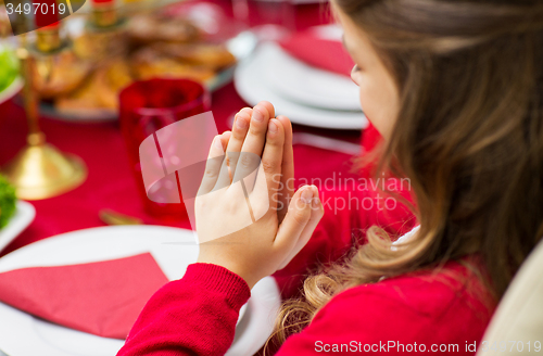 Image of close up of girl praying at christmas dinner