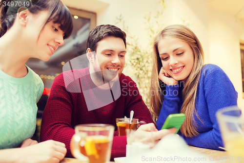 Image of group of friends with smartphone meeting at cafe
