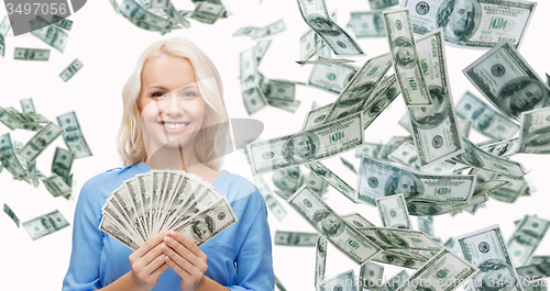 Image of smiling businesswoman with dollar cash money