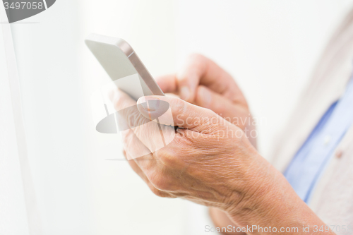 Image of close up of senior woman with smartphone texting