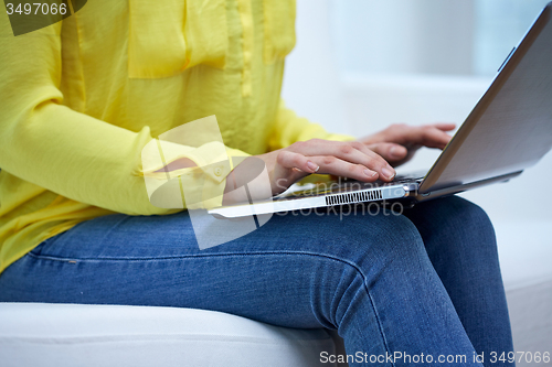 Image of close up of woman with laptop computer at home