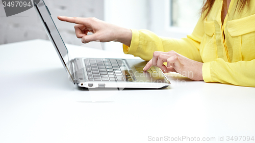 Image of close up of woman with laptop computer in office