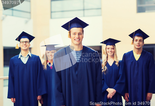 Image of group of smiling students in mortarboards