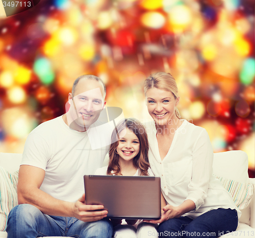 Image of smiling family with laptop