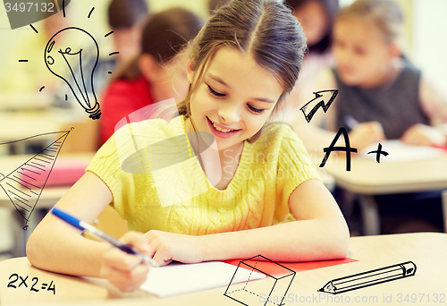 Image of group of school kids writing test in classroom