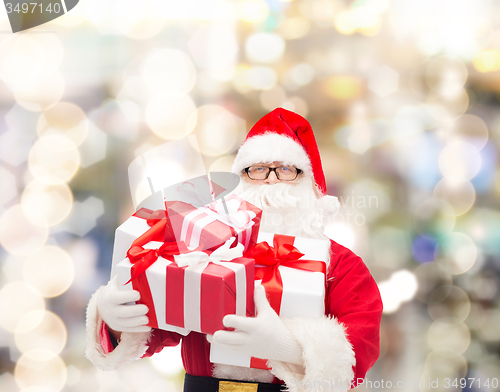 Image of man in costume of santa claus with gift boxes