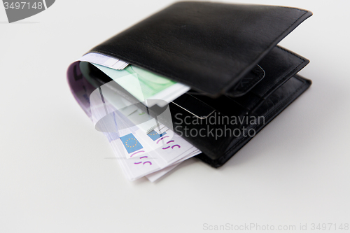 Image of close up of euro paper money in wallet on table