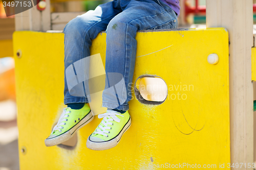 Image of close up of boy legs on children playground